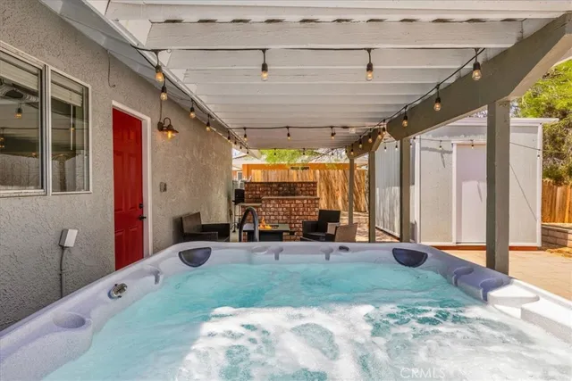 a kitchen with stainless steel appliances kitchen island granite countertop a refrigerator a stove and a sink with granite countertops