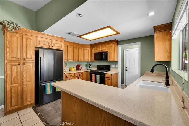 a kitchen with stainless steel appliances a sink stove and refrigerator