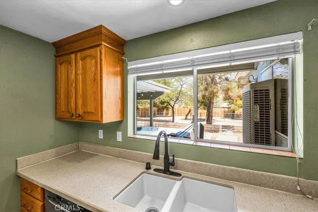 a dining room with furniture a rug and a kitchen
