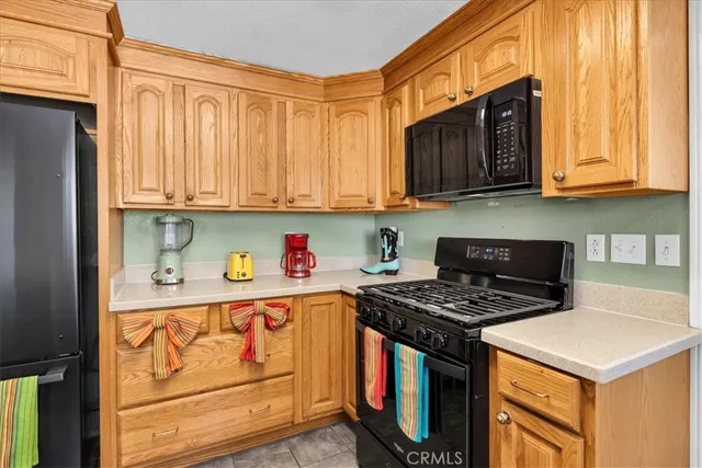 a kitchen with a dining table chairs and a chandelier