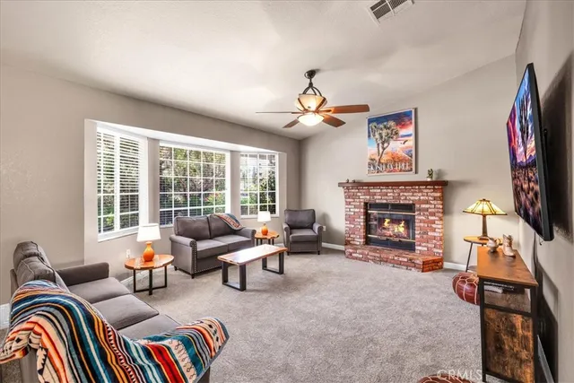 a living room with furniture fireplace and flat screen tv
