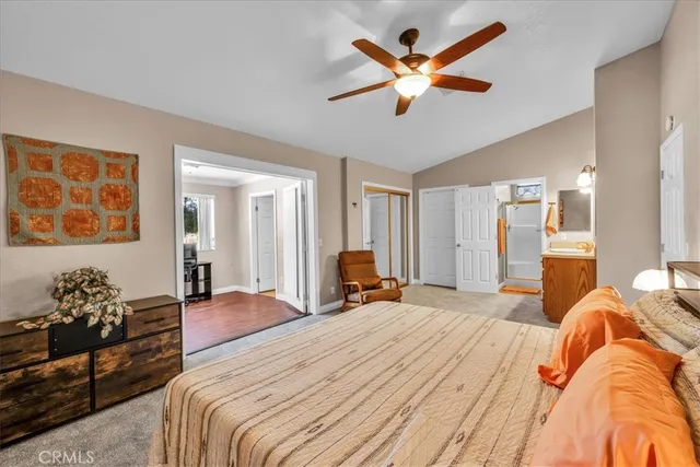 a spacious bedroom with a bed and a large window