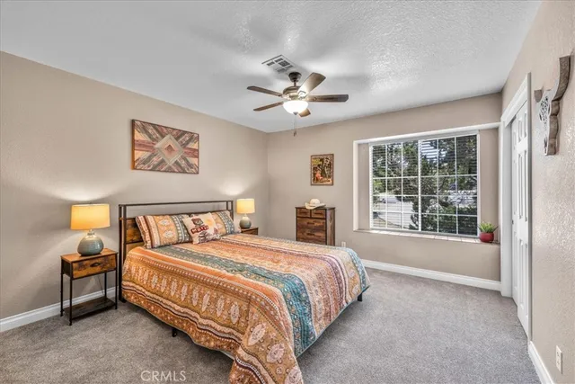 a bedroom with two beds and a window