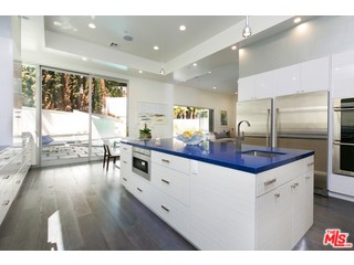 12263 Renfrew Road Los Angeles, CA 90049 - Photo 15 of 42 a large kitchen with granite countertop a large counter top a sink appliances and cabinets