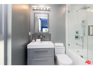 12263 Renfrew Road Los Angeles, CA 90049 - Photo 22 of 42 a bathroom with a sink toilet vanity and shower