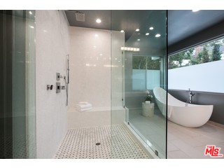 12263 Renfrew Road Los Angeles, CA 90049 - Photo 27 of 42 a bathroom with a glass shower door