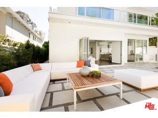 12263 Renfrew Road Los Angeles, CA 90049 - Photo 32 of 42 a view of a patio with couches table and chairs with wooden floor