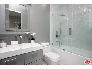 12263 Renfrew Road Los Angeles, CA 90049 - Photo 5 of 42 a bathroom with a sink toilet a shower and a mirror