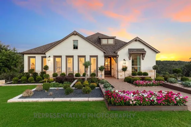 a front view of a house with a yard table and chairs