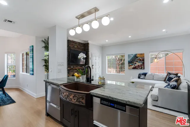 a kitchen with granite countertop a sink and a stove