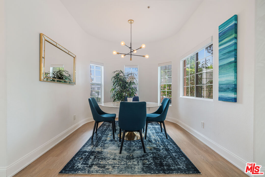 1531 12th Street, Unit 1 Santa Monica, CA 90401 - Photo 12 of 21 a dining room with furniture a rug and wooden floor