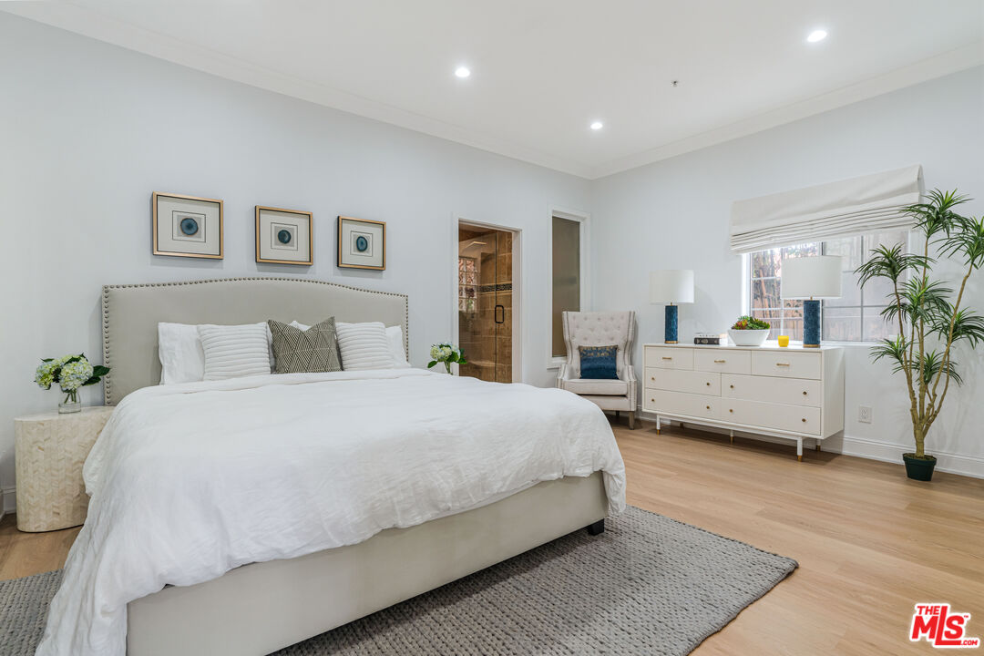 1531 12th Street, Unit 1 Santa Monica, CA 90401 - Photo 14 of 21 a spacious bedroom with a bed a couch and paintings on the wall