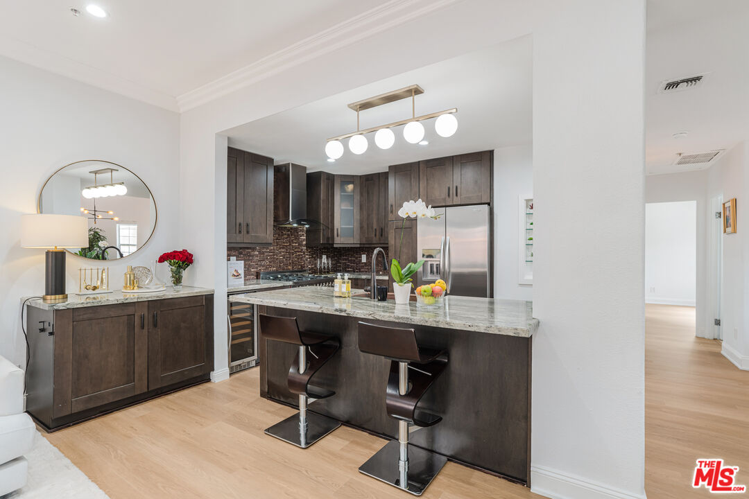 1531 12th Street, Unit 1 Santa Monica, CA 90401 - Photo 7 of 21 a kitchen with a sink cabinets and wooden floor