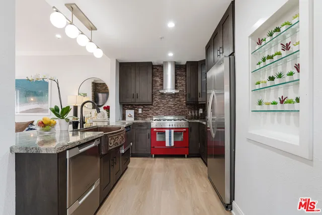 a kitchen with stainless steel appliances granite countertop a sink stove and refrigerator