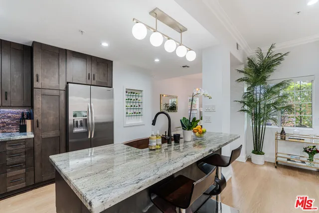 a kitchen with granite countertop a counter space cabinets and stainless steel appliances