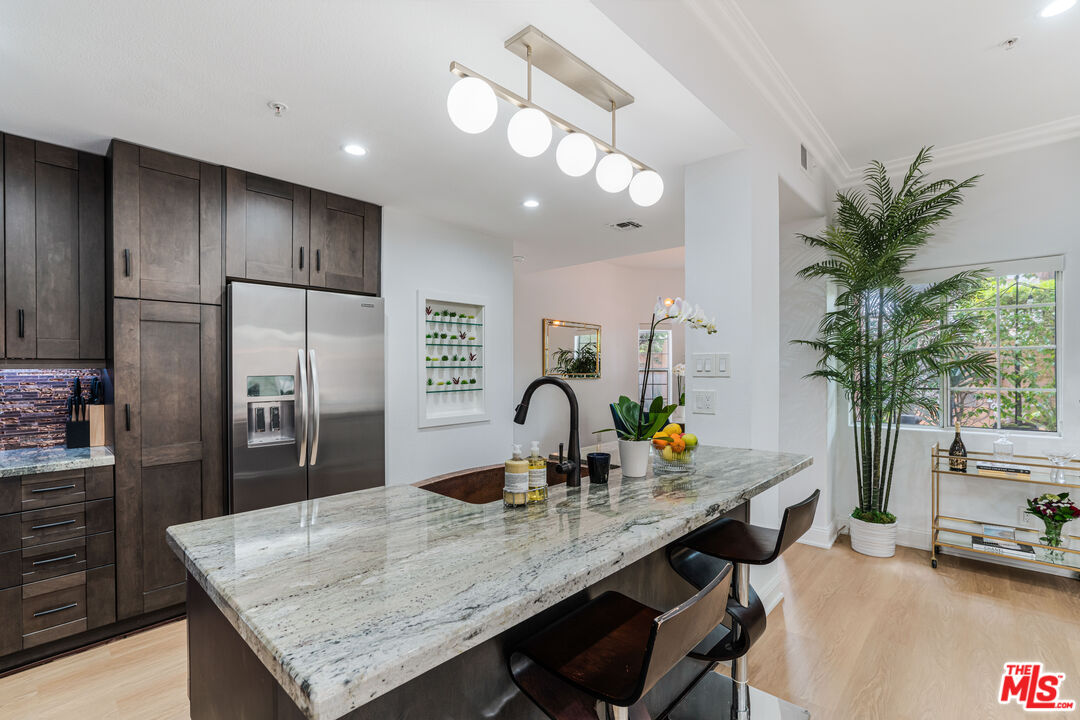 1531 12th Street, Unit 1 Santa Monica, CA 90401 - Photo 10 of 21 a kitchen with granite countertop a counter space cabinets and stainless steel appliances