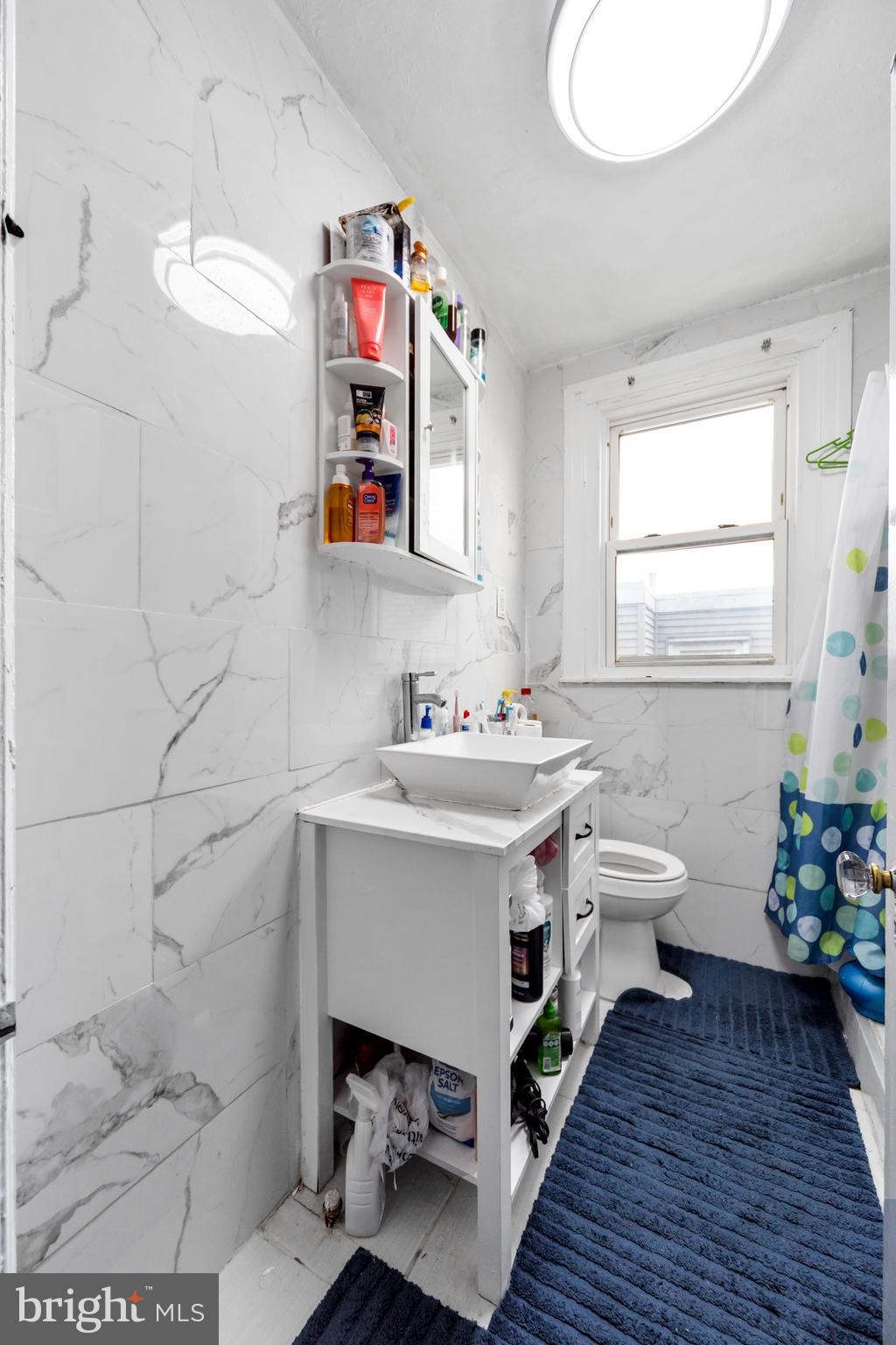 7517 Parkview Road Upper Darby, PA 19082 - Photo 15 of 33 a bathroom with a sink mirror and toilet