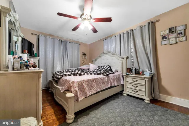 a bedroom with a bed dresser and a window