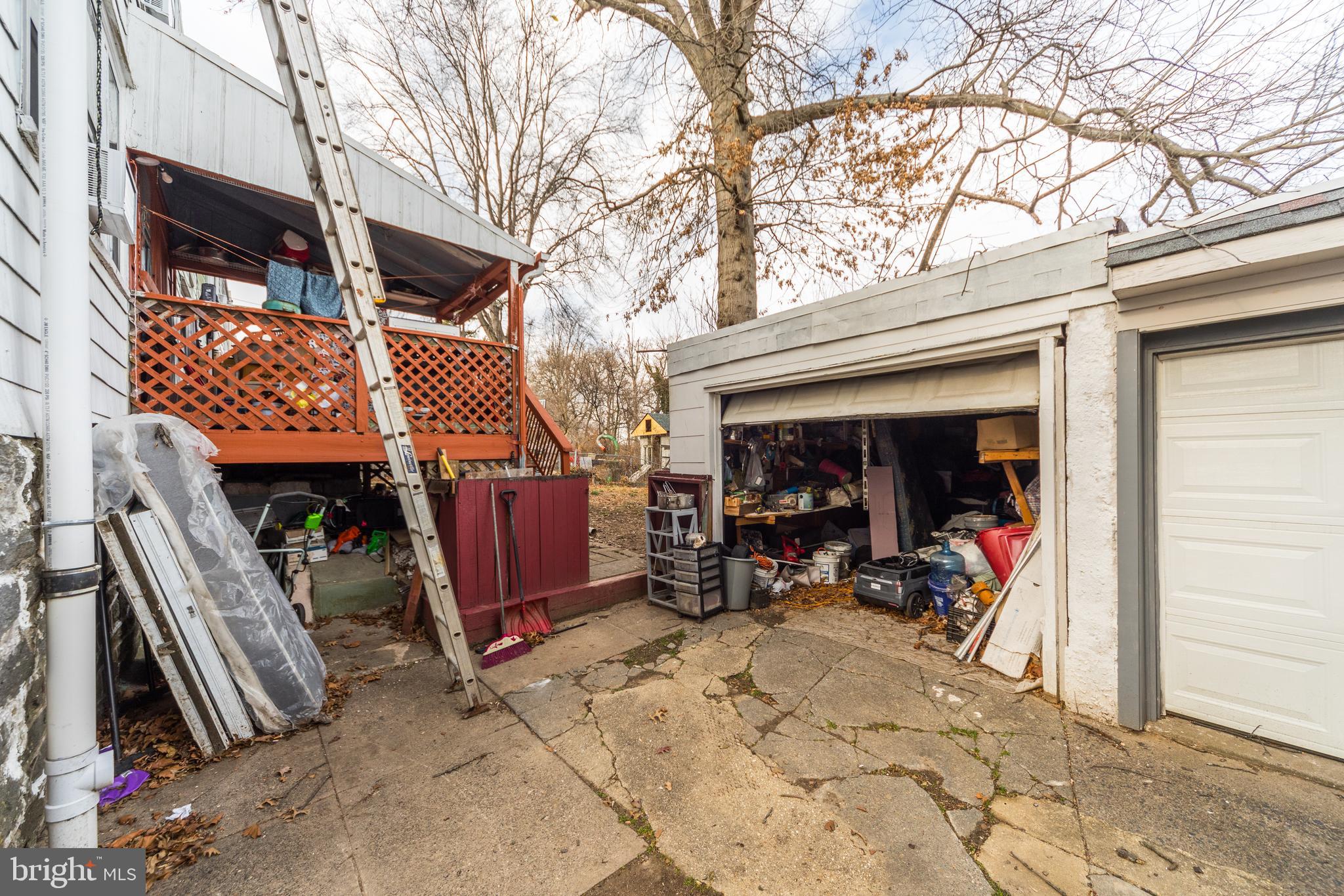 7517 Parkview Road Upper Darby, PA 19082 - Photo 23 of 33 a view of a chairs setting on the deck in front of retail shop