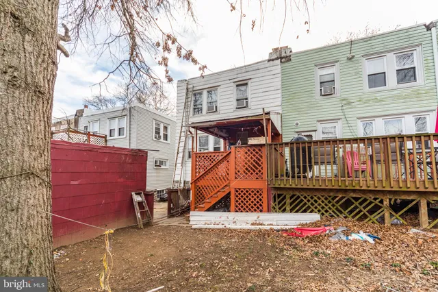 a view of a house with a wooden fence