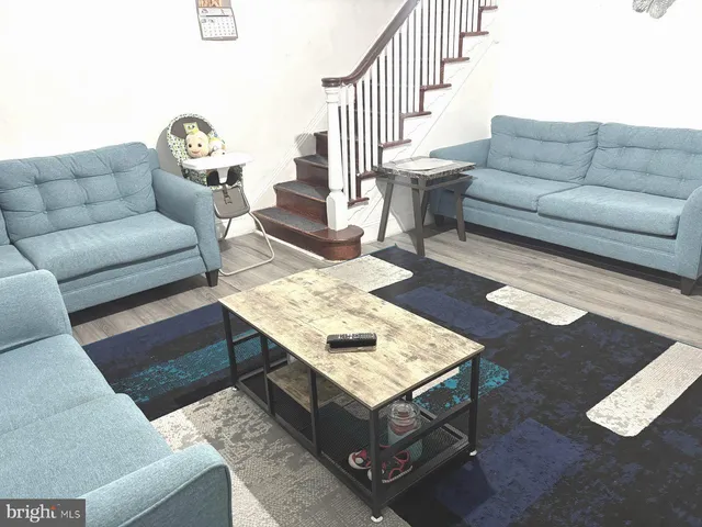 a living room with furniture and a rug