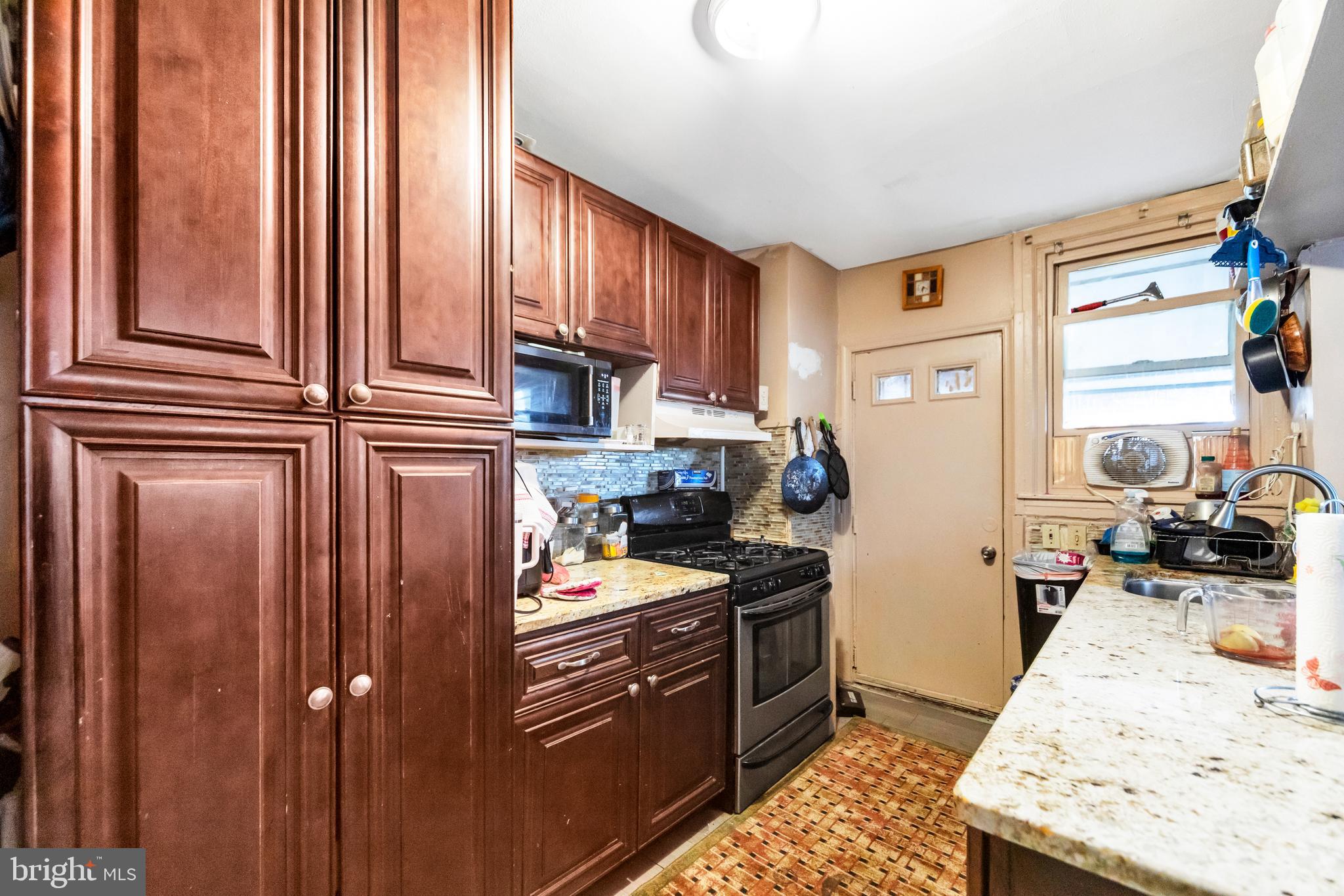 7517 Parkview Road Upper Darby, PA 19082 - Photo 8 of 33 a kitchen with stainless steel appliances granite countertop a refrigerator and stove