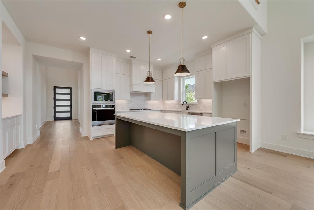 16396 Parish Lane Frisco, TX 75033 - Photo 13 of 35 a large kitchen with kitchen island a sink stainless steel appliances and cabinets