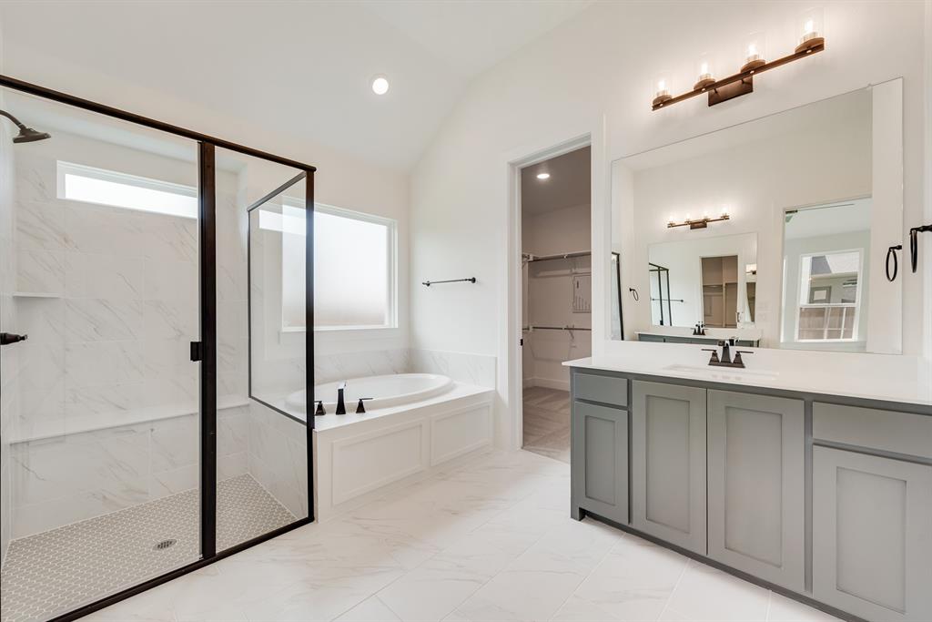 16396 Parish Lane Frisco, TX 75033 - Photo 18 of 35 a bathroom with a tub sink shower and mirror