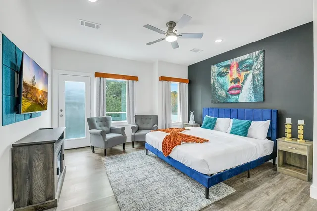 a bedroom with a bed and a chandelier