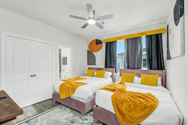 a bedroom with a bed and wooden floor