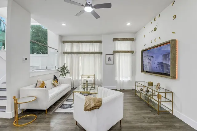 a living room with furniture and wooden floor