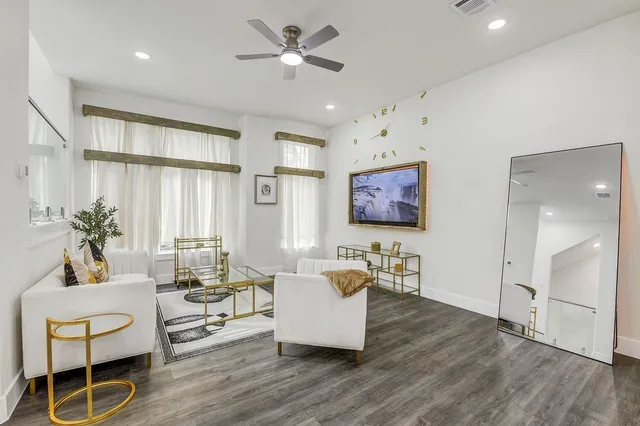 a living room with furniture or kitchen view and a chandelier