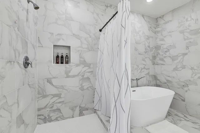 a bathroom with a bathtub and shower