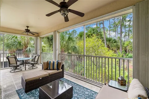 a bedroom with furniture and a large window