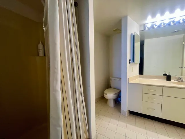 a bathroom with a toilet a sink and a mirror
