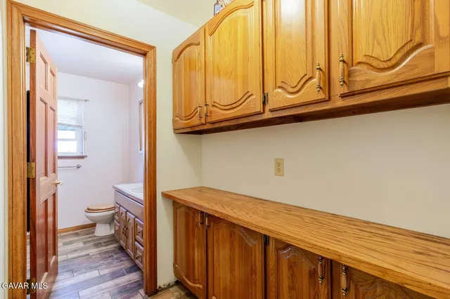 a bathroom with a sink toilet and window