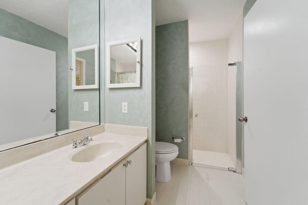 5562 Reynolds Road Lake Worth, FL 33449 - Photo 11 of 39 a bathroom with a sink and mirror with toilet