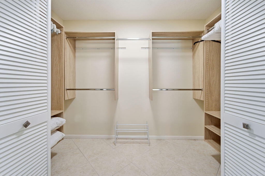 5562 Reynolds Road Lake Worth, FL 33449 - Photo 12 of 39 a bathroom with a glass shower door