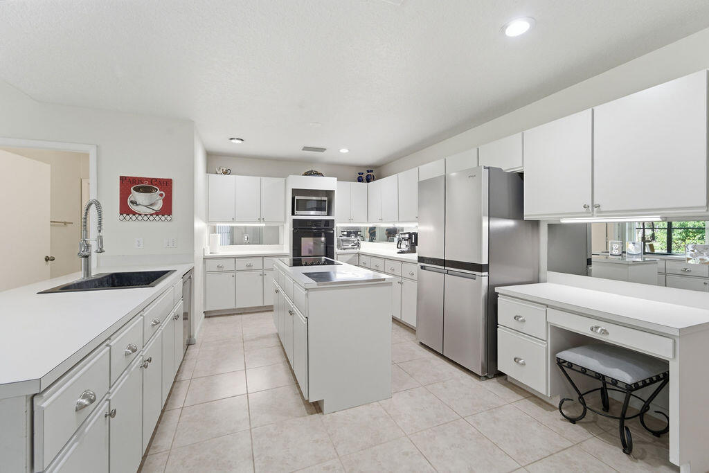 5562 Reynolds Road Lake Worth, FL 33449 - Photo 13 of 39 a kitchen with a sink window and stainless steel appliances