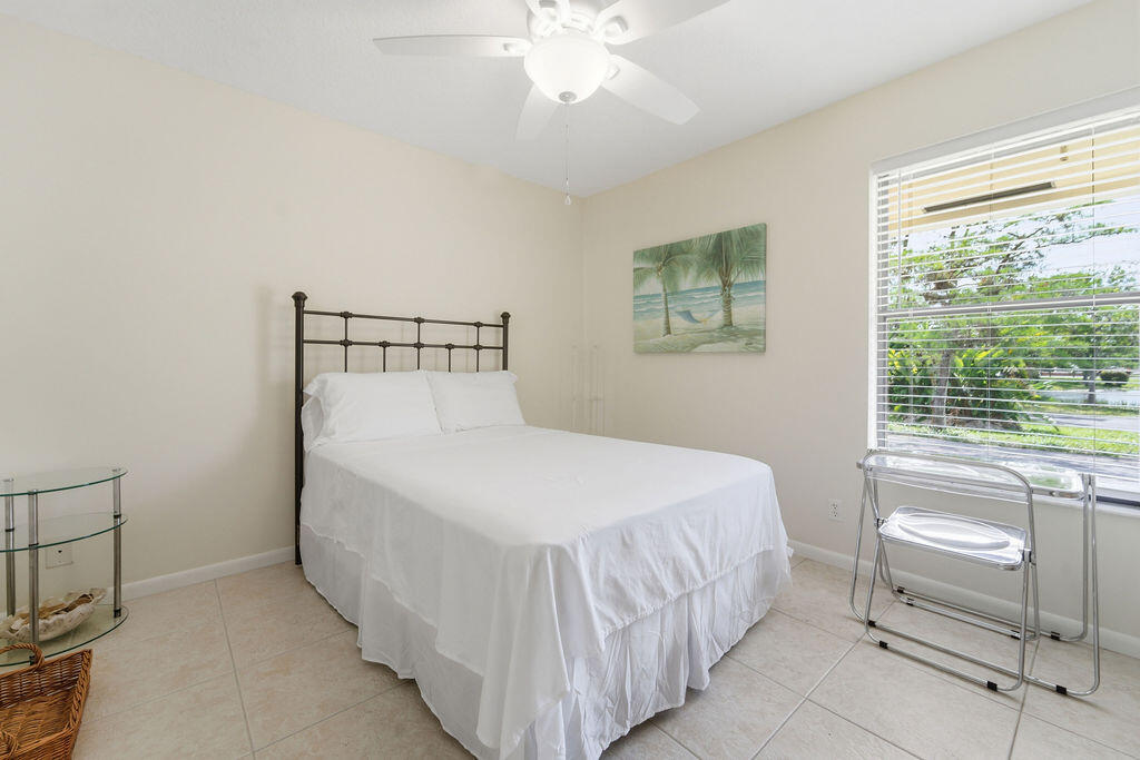 5562 Reynolds Road Lake Worth, FL 33449 - Photo 18 of 39 a bedroom with a bed and a table