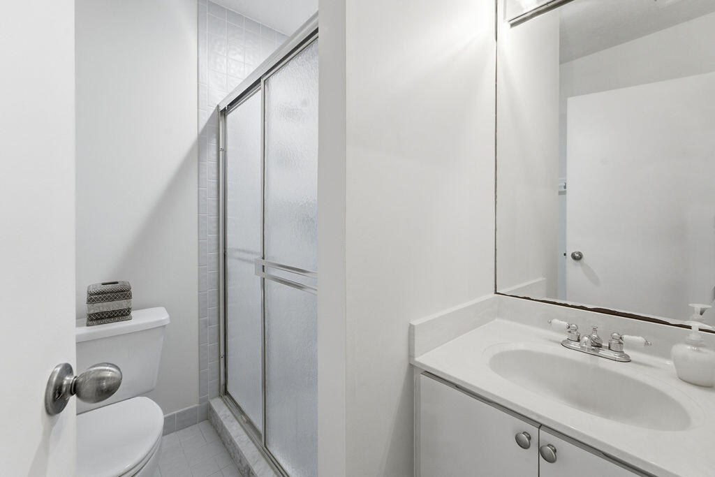 5562 Reynolds Road Lake Worth, FL 33449 - Photo 20 of 39 a bathroom with a sink a toilet and shower