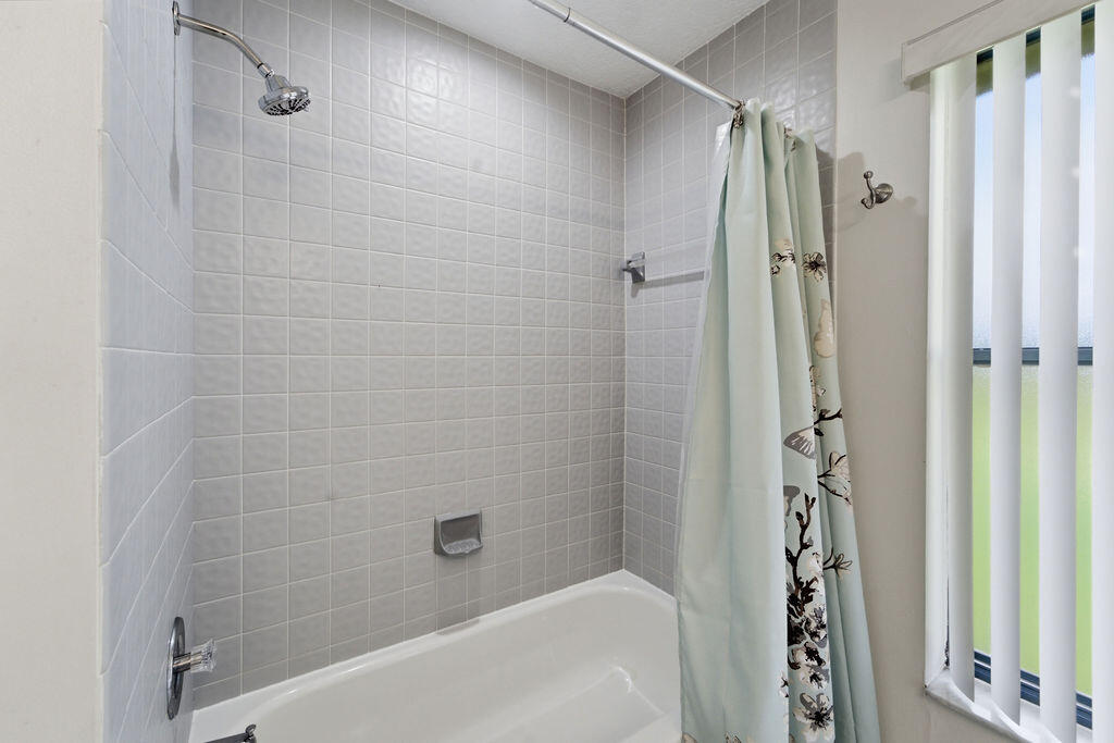 5562 Reynolds Road Lake Worth, FL 33449 - Photo 25 of 39 a bathroom with a bathtub and shower
