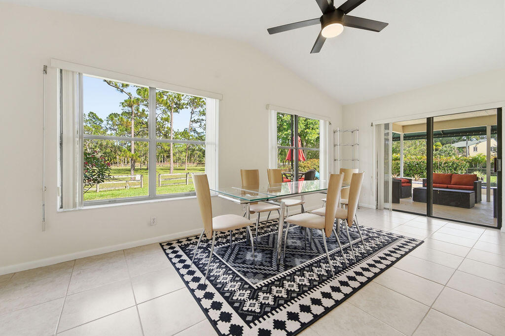 5562 Reynolds Road Lake Worth, FL 33449 - Photo 26 of 39 a view of a dining room with furniture window and outside view