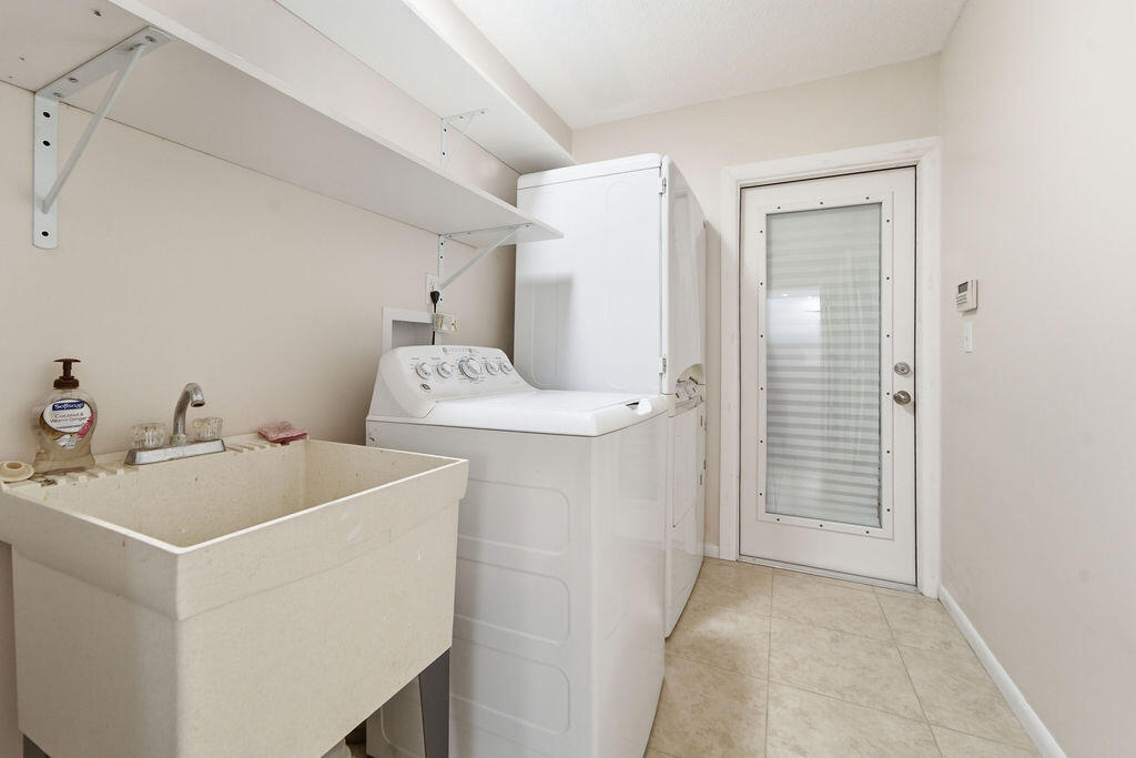 5562 Reynolds Road Lake Worth, FL 33449 - Photo 29 of 39 a utility room with dryer and washer