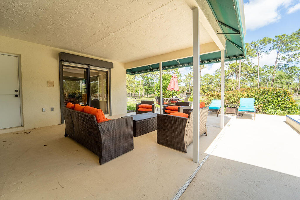 5562 Reynolds Road Lake Worth, FL 33449 - Photo 30 of 39 a living room with furniture and a large window