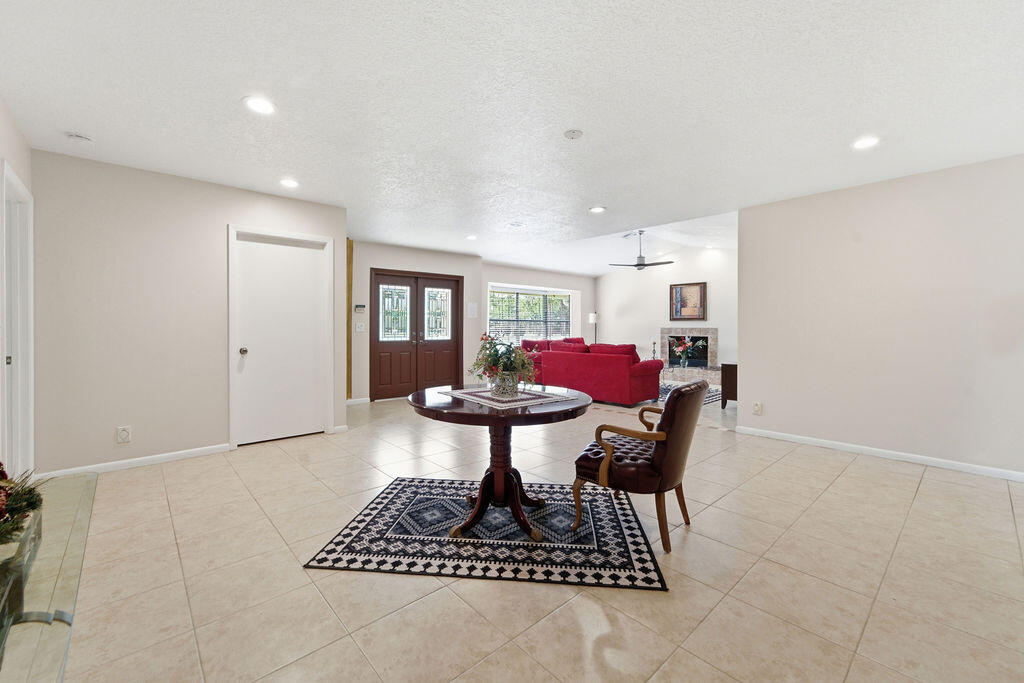 5562 Reynolds Road Lake Worth, FL 33449 - Photo 3 of 39 a living room with furniture a dining table and a potted plant