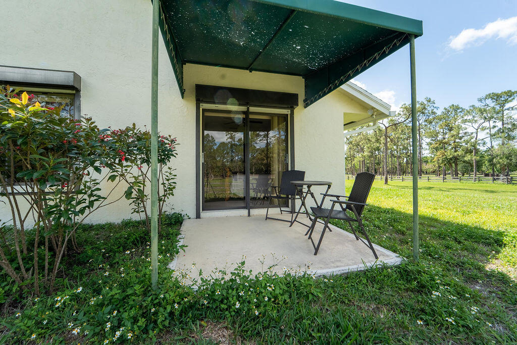 5562 Reynolds Road Lake Worth, FL 33449 - Photo 32 of 39 a garden view with a seating space