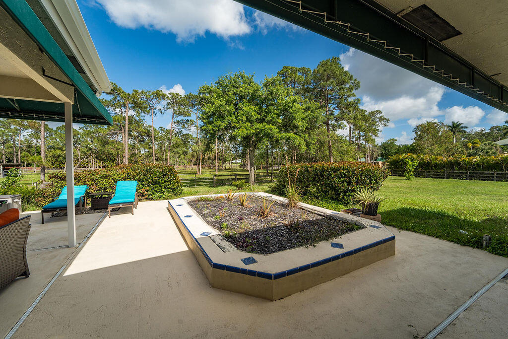 5562 Reynolds Road Lake Worth, FL 33449 - Photo 34 of 39 a view of backyard with swimming pool and outdoor seating