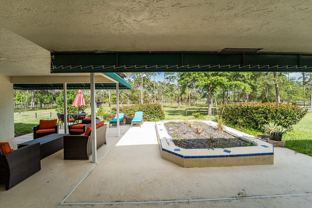 5562 Reynolds Road Lake Worth, FL 33449 - Photo 35 of 39 a view of a chairs and tables in the patio