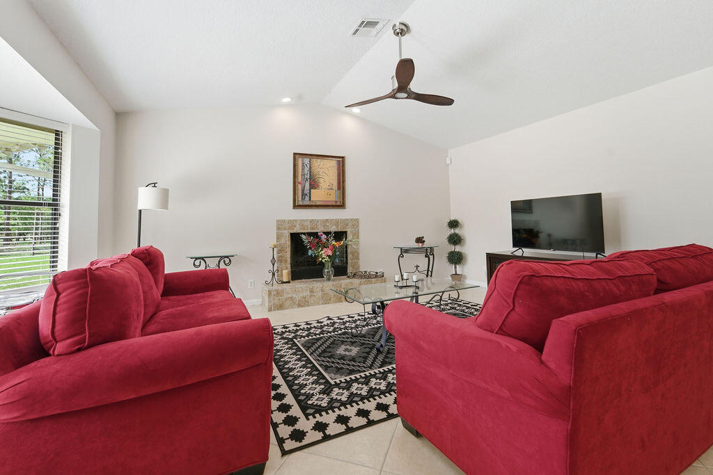 5562 Reynolds Road Lake Worth, FL 33449 - Photo 5 of 39 a living room with furniture or couch and a fireplace